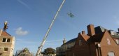 large retractable roof crane lift glass sky